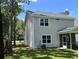 View of the rear exterior featuring a screened-in porch and large backyard at 641 Magnolia Rd, Charleston, SC 29407