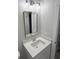 Bright bathroom features stylish vanity, sink with chrome faucet, mirror, and updated lighting at 641 Magnolia Rd, Charleston, SC 29407