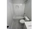 Modern bathroom featuring a subway-tiled shower, updated fixtures and attractive marble flooring at 641 Magnolia Rd, Charleston, SC 29407