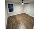 Bedroom features a ceiling fan, wood floors and large window at 641 Magnolia Rd, Charleston, SC 29407