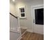 Bright entryway with staircase, wood-look flooring, adjacent to a large window and exterior door at 641 Magnolia Rd, Charleston, SC 29407