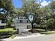 Charming two-story home featuring a two-car garage, white exterior, and a beautiful mature tree in the front yard at 641 Magnolia Rd, Charleston, SC 29407