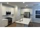 Spacious kitchen with white cabinetry, stainless steel appliances, and a large center island at 641 Magnolia Rd, Charleston, SC 29407
