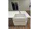 Modern kitchen island with white quartz countertops and a farmhouse sink, complimented by stainless steel appliances at 641 Magnolia Rd, Charleston, SC 29407