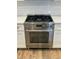 Close-up of the stainless steel oven and range featuring white subway tile backsplash at 641 Magnolia Rd, Charleston, SC 29407