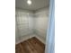 Open walk-in closet with custom shelving and hardwood floors at 641 Magnolia Rd, Charleston, SC 29407
