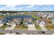 Scenic aerial view of homes with well-maintained lawns, overlooking a tranquil pond in a residential neighborhood at 658 Yellow Leaf Ln, Summerville, SC 29486