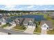 Aerial view of a home with a two-car garage, well-maintained landscaping and community lake at 658 Yellow Leaf Ln, Summerville, SC 29486