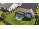 Aerial view of a well-manicured backyard featuring a patio area, seating, and lush green lawn at 658 Yellow Leaf Ln, Summerville, SC 29486