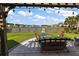 Charming backyard with outdoor seating and a scenic view of the nearby pond at 658 Yellow Leaf Ln, Summerville, SC 29486