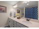 Bright bathroom featuring double sinks, a large mirror, vanity, and a tub with a shower curtain at 658 Yellow Leaf Ln, Summerville, SC 29486