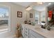 Bright bathroom featuring a large vanity, well-lit mirror, and a window with natural light at 658 Yellow Leaf Ln, Summerville, SC 29486