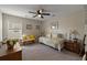 Bright bedroom features carpet, a ceiling fan, and a sitting area with natural light at 658 Yellow Leaf Ln, Summerville, SC 29486