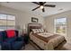 Cozy bedroom with a comfortable bed, a ceiling fan, and two sunny windows with blinds at 658 Yellow Leaf Ln, Summerville, SC 29486