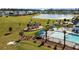 Aerial view of neighborhood playground and pool area near a picturesque lake in a beautiful community at 658 Yellow Leaf Ln, Summerville, SC 29486