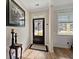 Inviting entryway with dark door, sidelight, and wood-look floors at 658 Yellow Leaf Ln, Summerville, SC 29486