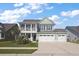 Inviting two-story home with a charming front porch, landscaped lawn and a two car garage at 658 Yellow Leaf Ln, Summerville, SC 29486