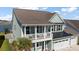 Exterior view of a two-story home featuring a cozy front porch and two-car garage at 658 Yellow Leaf Ln, Summerville, SC 29486