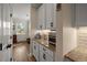 Butler's pantry featuring granite countertops and hardwood floors and white cabinets at 658 Yellow Leaf Ln, Summerville, SC 29486