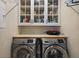 Functional laundry room with washer, dryer, and storage cabinets at 658 Yellow Leaf Ln, Summerville, SC 29486