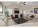 Bright living room with fireplace, hardwood floors, ceiling fan and beige sectional sofa and access to the patio at 658 Yellow Leaf Ln, Summerville, SC 29486