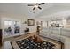 Bright living room featuring hardwood floors, ceiling fan, beige sectional sofa and access to the kitchen at 658 Yellow Leaf Ln, Summerville, SC 29486