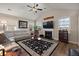 Cozy living room with a fireplace, hardwood floors, ceiling fan and a comfortable beige sectional sofa at 658 Yellow Leaf Ln, Summerville, SC 29486