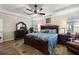 Comfortable main bedroom features tray ceilings, ceiling fan, and a large rug at 658 Yellow Leaf Ln, Summerville, SC 29486