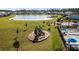 Community playground with slides and climbing structures, situated near a pond and pool area at 658 Yellow Leaf Ln, Summerville, SC 29486
