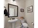 Cozy half bath with pedestal sink and decorative mirror at 658 Yellow Leaf Ln, Summerville, SC 29486