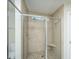 Bathroom featuring a tiled shower with glass doors and a built-in seat at 72 Crossandra Ave, Summerville, SC 29483