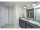 Bathroom featuring a double vanity with granite countertop and a large mirror with modern lighting at 72 Crossandra Ave, Summerville, SC 29483