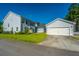 Two-story home with siding, black roof, manicured lawn, and a two-car garage at 72 Crossandra Ave, Summerville, SC 29483
