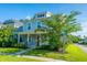 Two-story home with blue siding, inviting front porch, and lush landscaping on a sunny day at 72 Crossandra Ave, Summerville, SC 29483