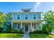 Charming two-story home with a welcoming front porch, well-manicured lawn, and blue horizontal siding at 72 Crossandra Ave, Summerville, SC 29483