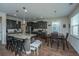 Eat-in kitchen featuring stainless appliances, dark cabinets, granite countertops, and an island with bar seating at 72 Crossandra Ave, Summerville, SC 29483