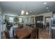 Open concept kitchen with granite counters and eat-in dining area, flowing into a comfortable living space at 72 Crossandra Ave, Summerville, SC 29483