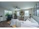 Bright living room with comfortable seating, dark wood floors, and ample natural light from large windows at 72 Crossandra Ave, Summerville, SC 29483