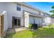 This backyard features a sliding glass door, white siding, grass and air conditioner at 7814 Nummie Ct, North Charleston, SC 29418