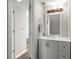This bathroom features a white vanity, mirror, lighting fixture, and neutral walls at 7814 Nummie Ct, North Charleston, SC 29418