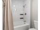 Bathroom with tub and shower combination with white tile surround and modern fixtures at 7814 Nummie Ct, North Charleston, SC 29418