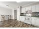 Kitchen featuring white cabinets and appliances, with an eat-in dining area at 7814 Nummie Ct, North Charleston, SC 29418