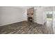 Living room with a stone fireplace, built-in shelving, and wood-look flooring, creating a cozy atmosphere at 7814 Nummie Ct, North Charleston, SC 29418
