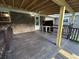 Spacious covered back porch with exposed wood beams and painted wood floors, perfect for outdoor gatherings at 8334 Witsell St, North Charleston, SC 29406