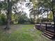 Large backyard featuring a spacious green lawn and an above ground pool with a wooden deck and stairs at 8334 Witsell St, North Charleston, SC 29406