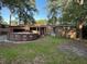 Image shows an above ground pool in the backyard, surrounded by lush greenery with a covered patio in the background at 8334 Witsell St, North Charleston, SC 29406