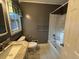 Bathroom featuring tiled floors, a shower-tub combo and a marble countertop at 8334 Witsell St, North Charleston, SC 29406