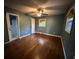 Bedroom featuring hardwood floors, window and an ensuite bathroom at 8334 Witsell St, North Charleston, SC 29406