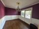 Dining room featuring hardwood floors, chair rail, bright windows and decorative chandelier at 8334 Witsell St, North Charleston, SC 29406