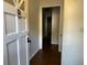 Entryway with wood floors, white door, and dark molding at 8334 Witsell St, North Charleston, SC 29406